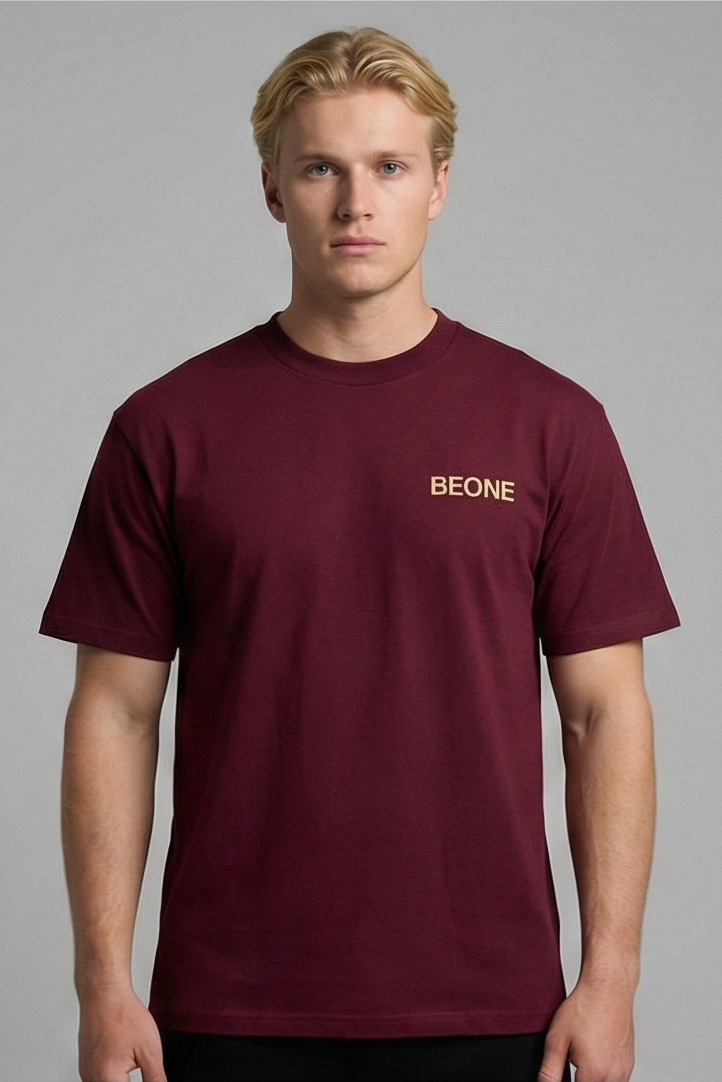 Man wearing a maroon t-shirt with 'Bekine' logo on a gray background