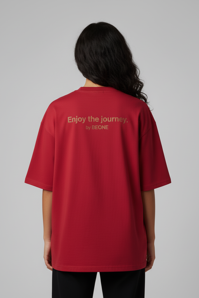 Person wearing a red t-shirt with text on the back against a gray background