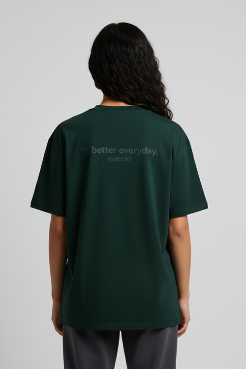 Person wearing a green t-shirt with 'better everyday' text on the back against a gray background