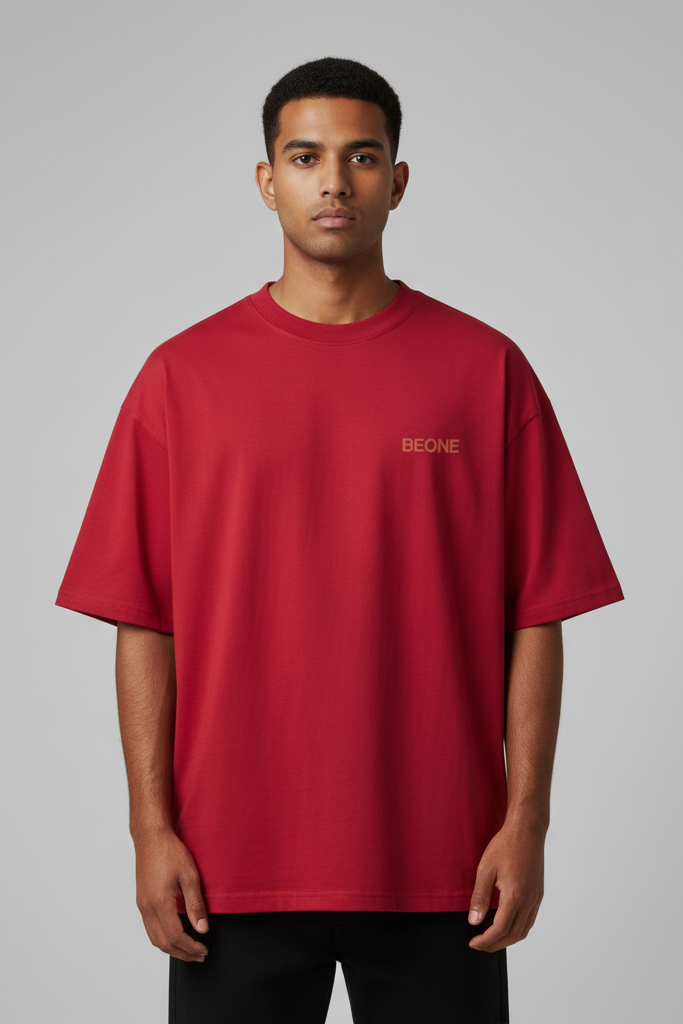 Man wearing a red t-shirt with 'BEONE' logo on a gray background