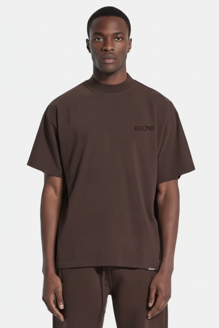 Man wearing a brown t-shirt with 'BEONE' logo on a white background