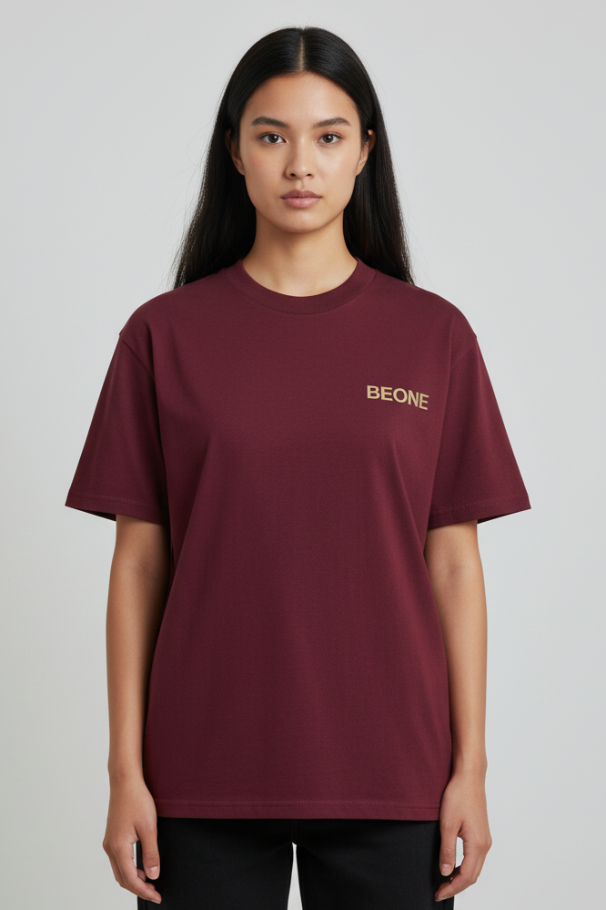 Person wearing a maroon t-shirt with 'BEONE' logo on a plain background