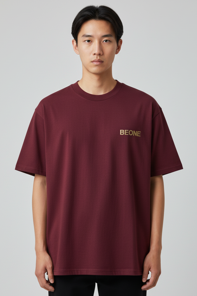 Person wearing a burgundy t-shirt with 'BEONE' logo on a gray background